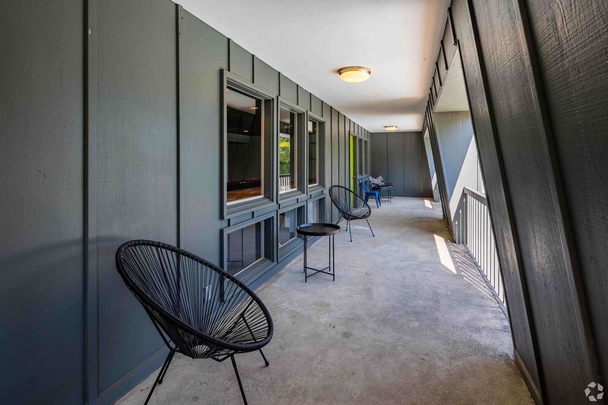 A balcony with a chair and a table.